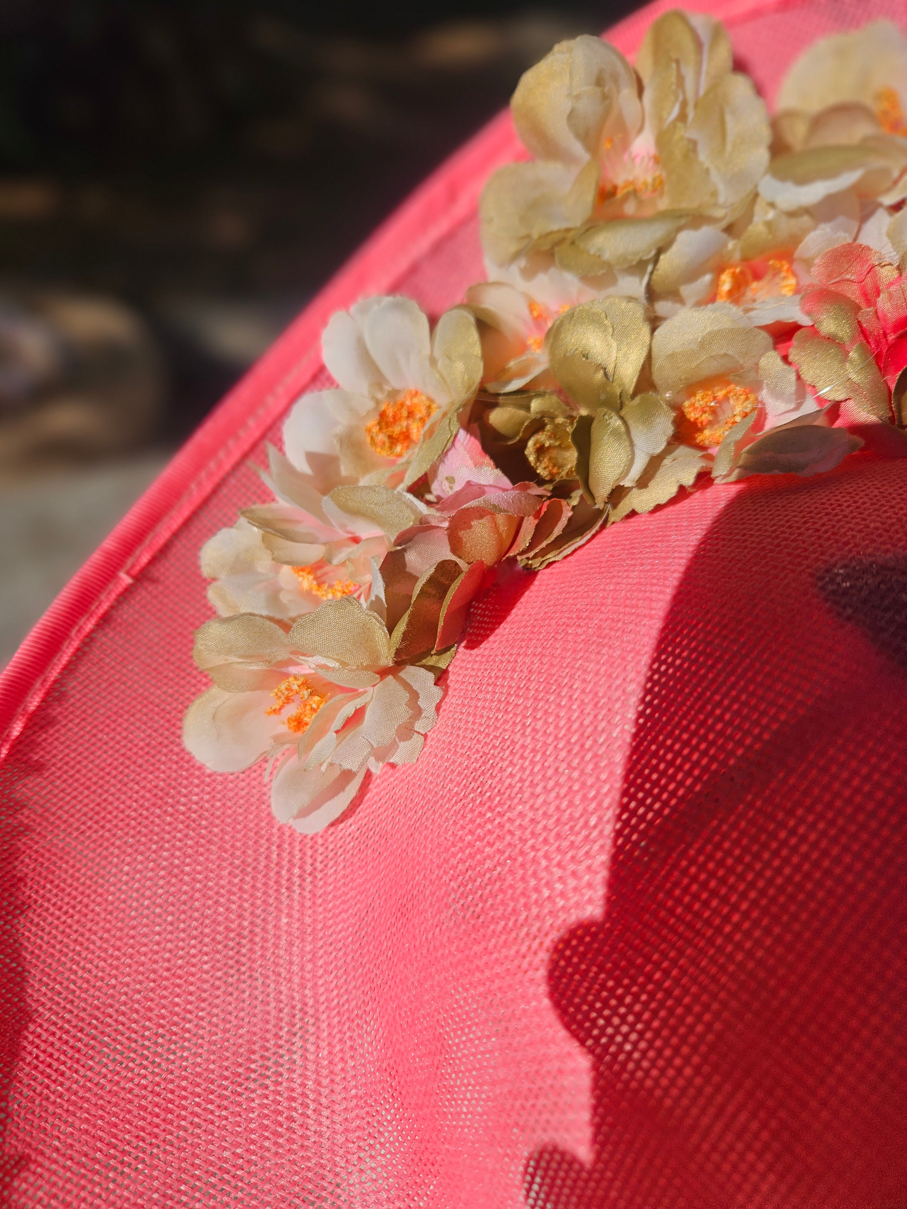 Pamela rosa con flores de tela crema y naranjas, toma lateral