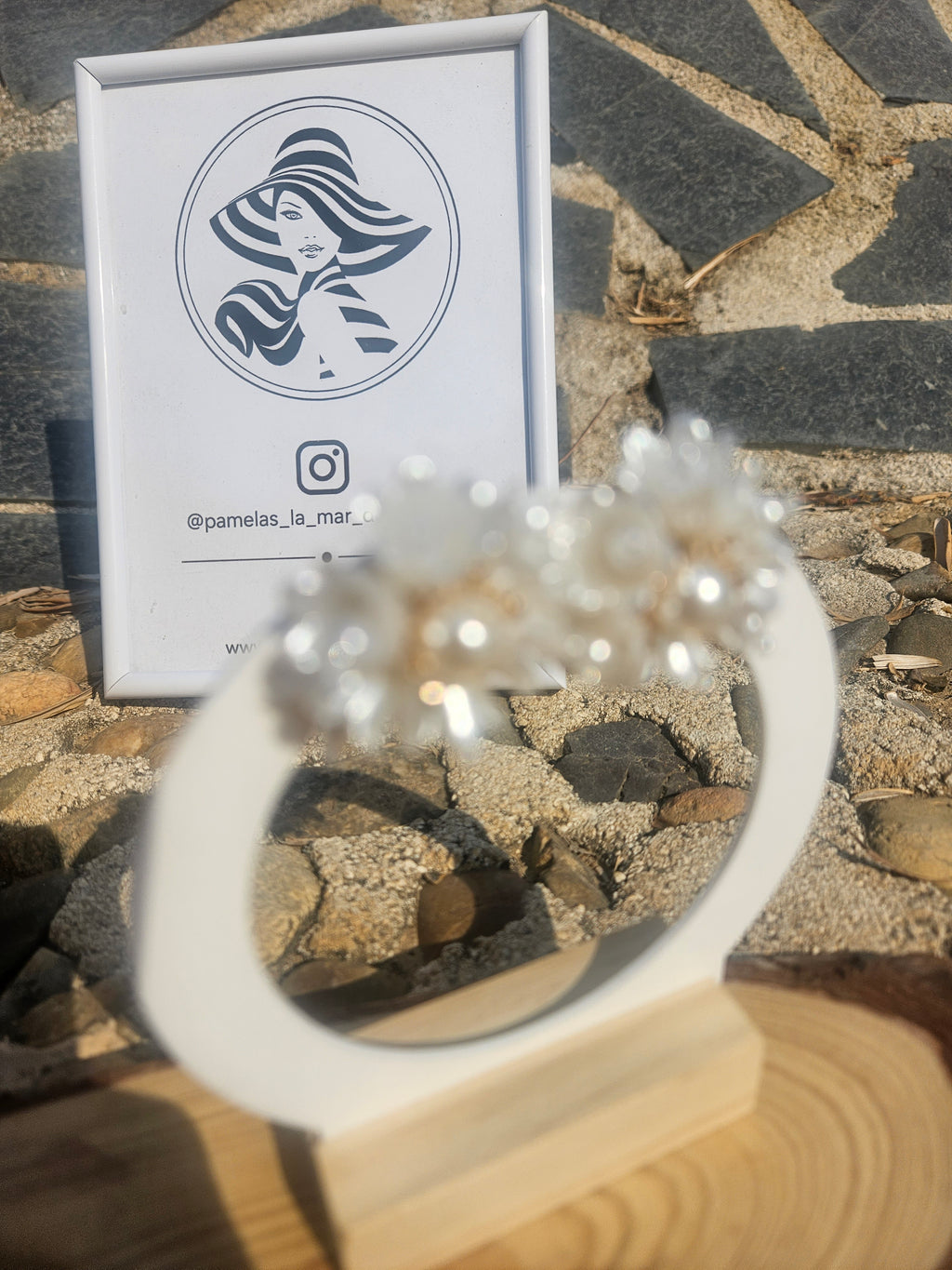 Pendiente floral blanco con centro de perla y acabado dorado, forma de pétalos