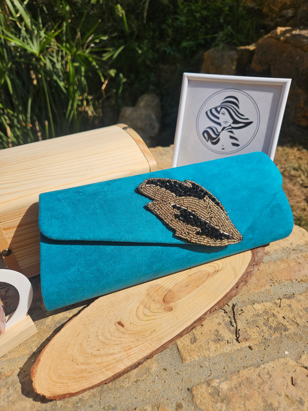 Bolso de ante turquesa con solapa curva y aplique bordado en forma de ojo