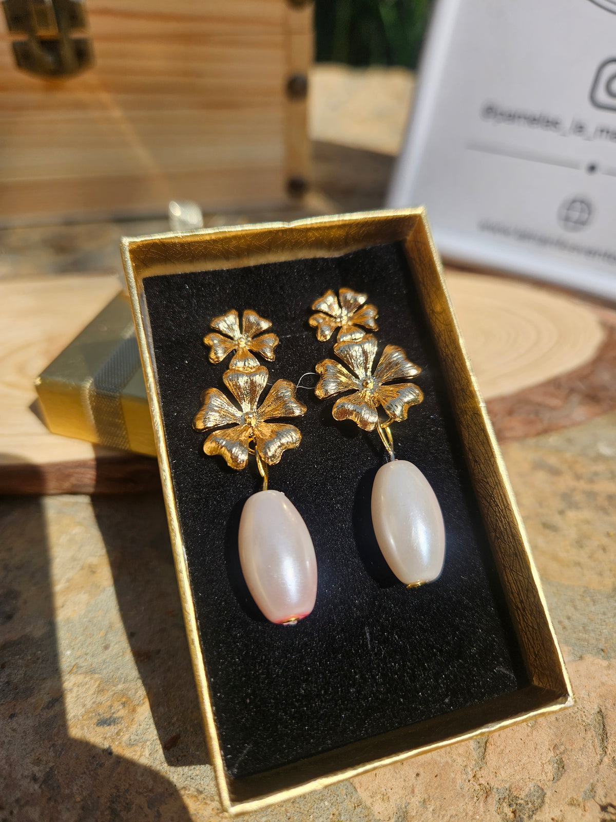 Pendientes dorados con motivos florales y gotas blancas tipo perla