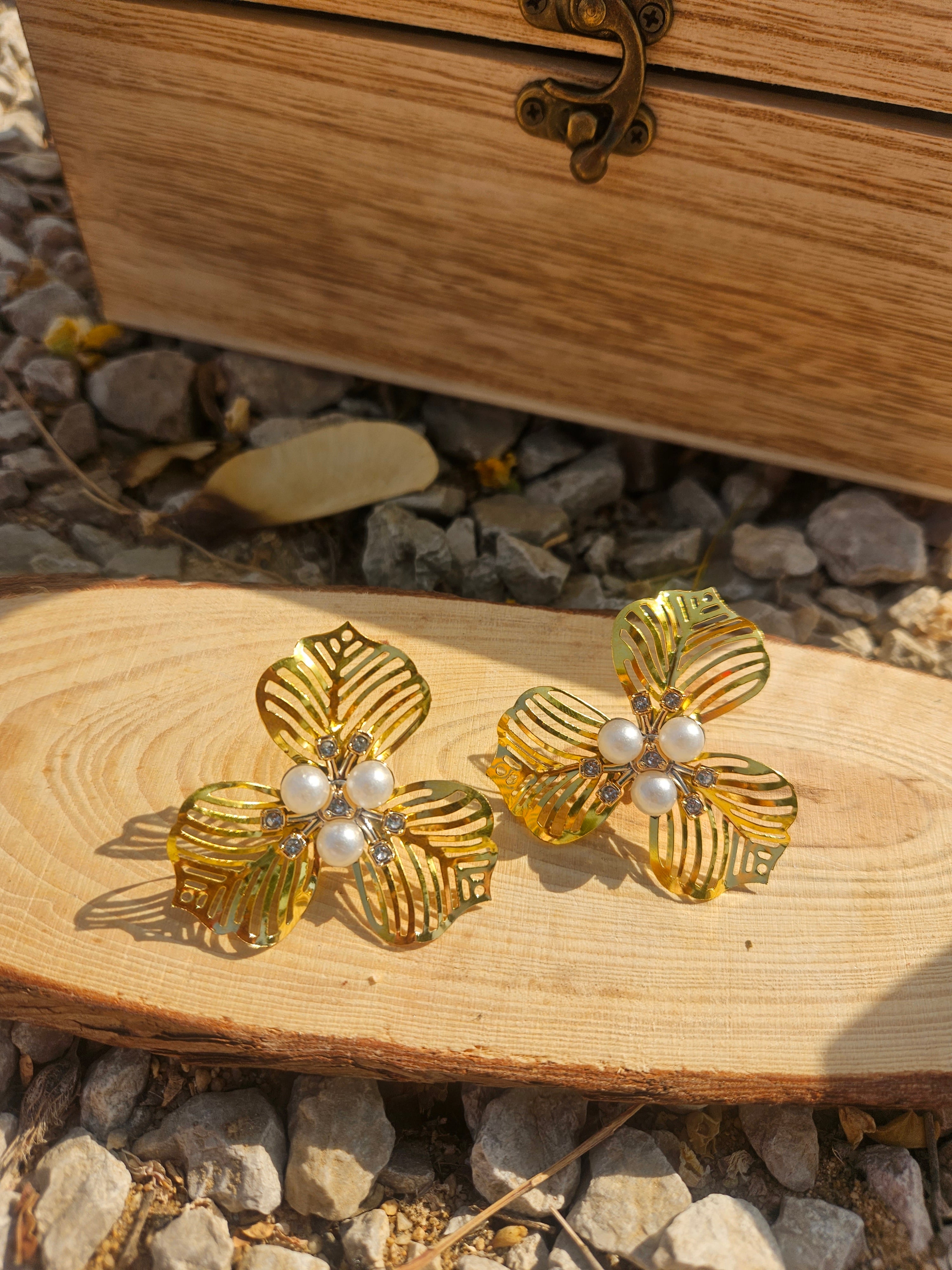 Pendientes florales dorados con perlas blancas y relieve de hojas