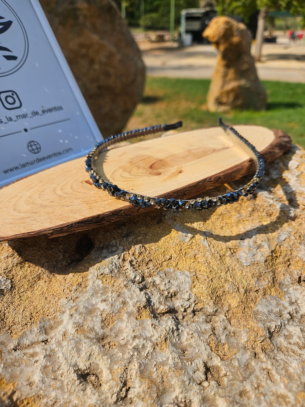 Diadema azul con pedrería brillante y abalorios sobre banda negra