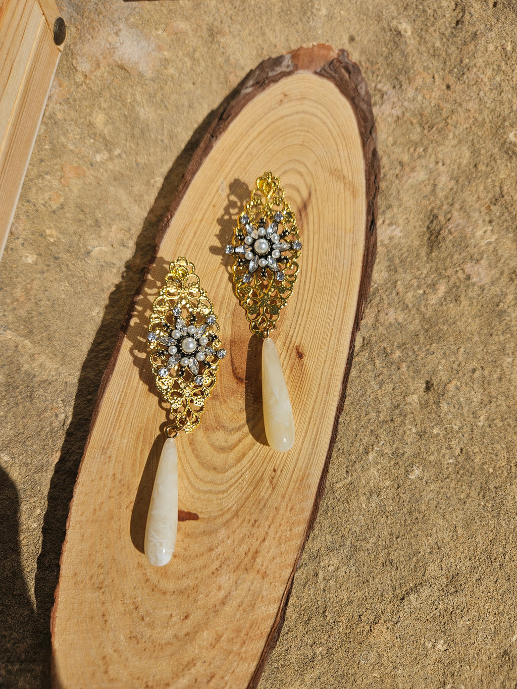 Pendientes tipo candelabro dorados con piedras y gotas marfil