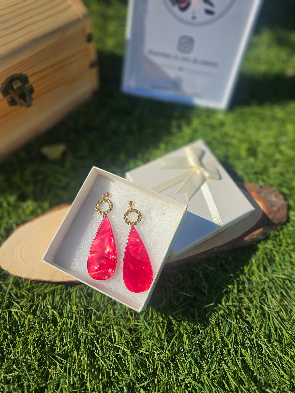 Pendientes con gotas rojas sobre soporte, con aro dorado y gancho de metal